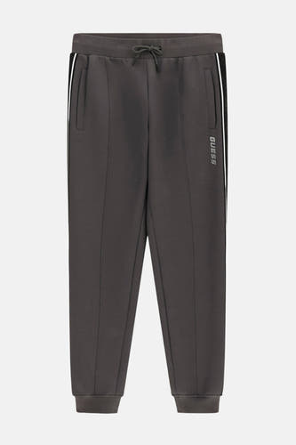 Jean de jogging gris Guess avec cordon à la taille et biais blanc sur le côté.